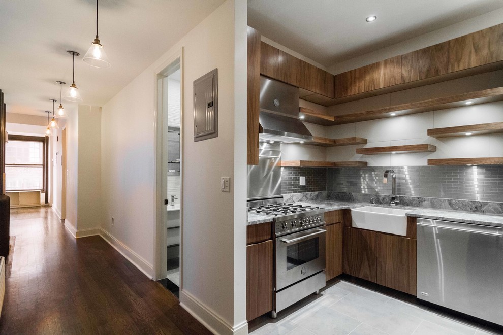 Example of a small trendy u-shaped porcelain tile and beige floor eat-in kitchen design in New York with a farmhouse sink, flat-panel cabinets, dark wood cabinets, quartz countertops, metallic backsplash, metal backsplash, stainless steel appliances and no island