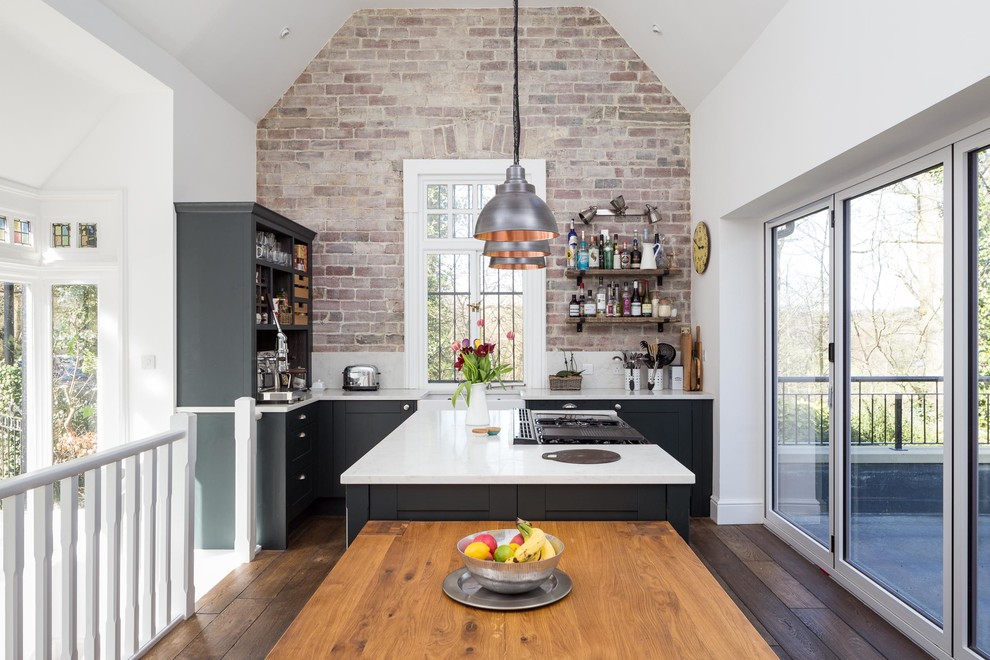 Design ideas for a medium sized country single-wall kitchen/diner in Other with shaker cabinets, blue cabinets, granite worktops, white splashback, stainless steel appliances, dark hardwood flooring, an island, brown floors, white worktops and a belfast sink.