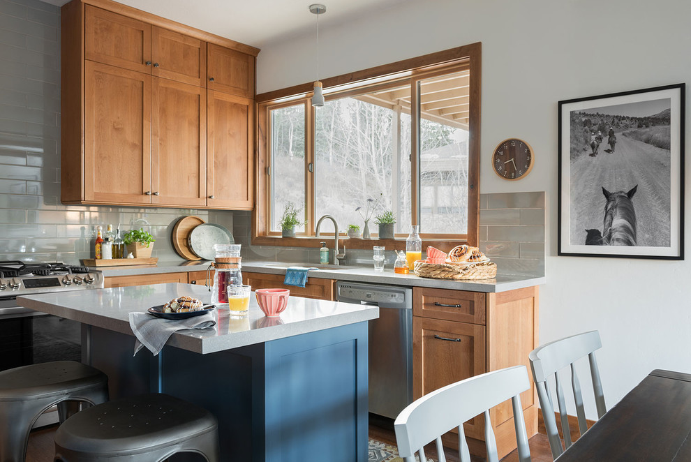 Design ideas for a classic u-shaped kitchen/diner with a submerged sink, shaker cabinets, medium wood cabinets, grey splashback, metro tiled splashback, stainless steel appliances, medium hardwood flooring, an island and brown floors.