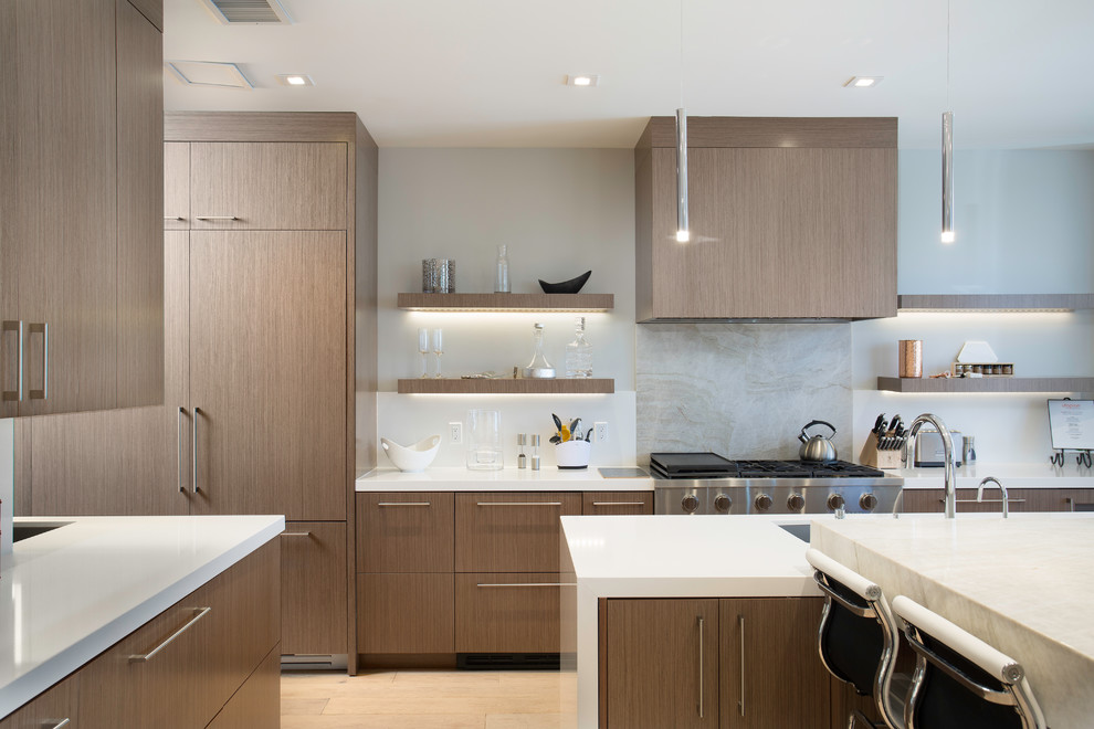 Inspiration for a medium sized l-shaped open plan kitchen in Salt Lake City with a submerged sink, flat-panel cabinets, beige cabinets, marble worktops, grey splashback, marble splashback, stainless steel appliances, bamboo flooring, multiple islands, beige floors and white worktops.