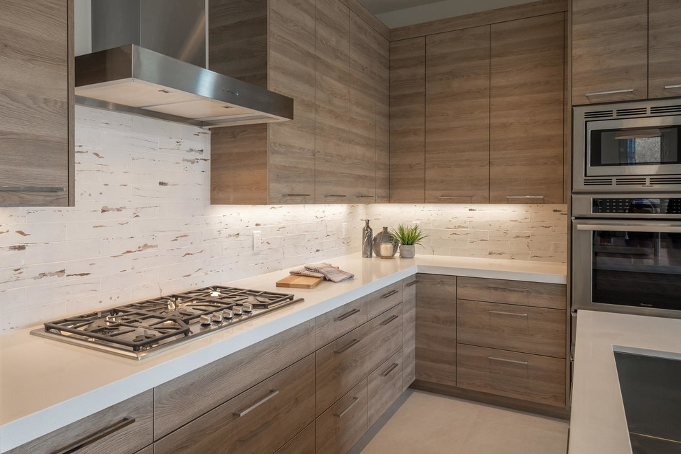 Mid-sized trendy l-shaped porcelain tile and beige floor open concept kitchen photo in Salt Lake City with an undermount sink, glass-front cabinets, medium tone wood cabinets, quartz countertops, white backsplash, stainless steel appliances, an island and white countertops
