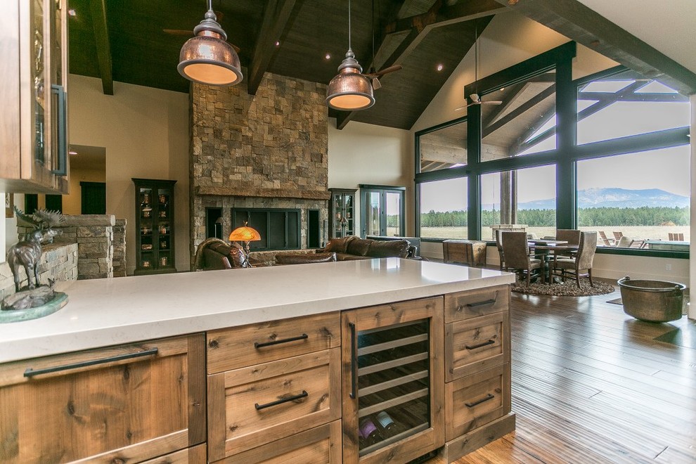 Example of a large arts and crafts single-wall medium tone wood floor and brown floor open concept kitchen design in Other with recessed-panel cabinets, medium tone wood cabinets, quartzite countertops, an island and white countertops