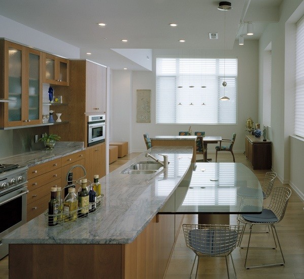 Eat-in kitchen - large modern l-shaped light wood floor and brown floor eat-in kitchen idea in Cincinnati with a double-bowl sink, flat-panel cabinets, medium tone wood cabinets, marble countertops, stainless steel appliances, an island, gray backsplash and stone slab backsplash