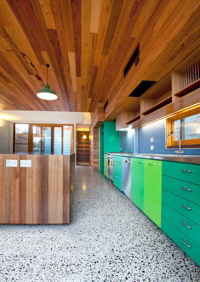 Kitchen - contemporary kitchen idea in Melbourne with flat-panel cabinets, green cabinets, blue backsplash and stainless steel appliances