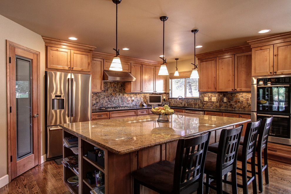 Traditional kitchen in Denver with stainless steel appliances and slate splashback.