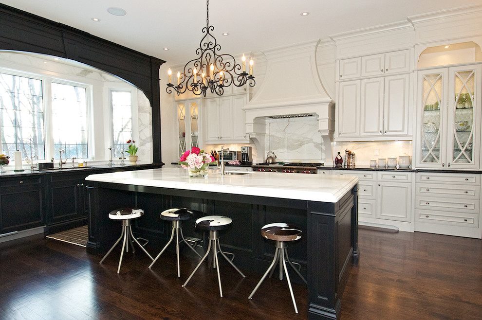 Photo of a large classic kitchen in Toronto with a submerged sink, recessed-panel cabinets, marble worktops, stone slab splashback, stainless steel appliances, dark hardwood flooring and an island.