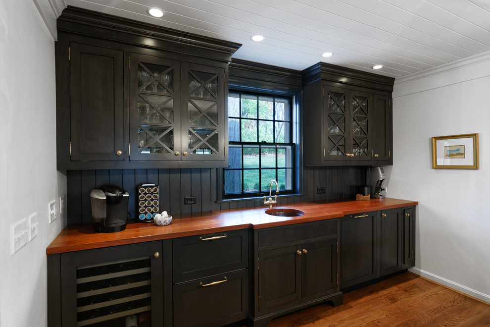 Kitchen - traditional medium tone wood floor kitchen idea in Cincinnati with an undermount sink, recessed-panel cabinets, dark wood cabinets, wood countertops and wood backsplash