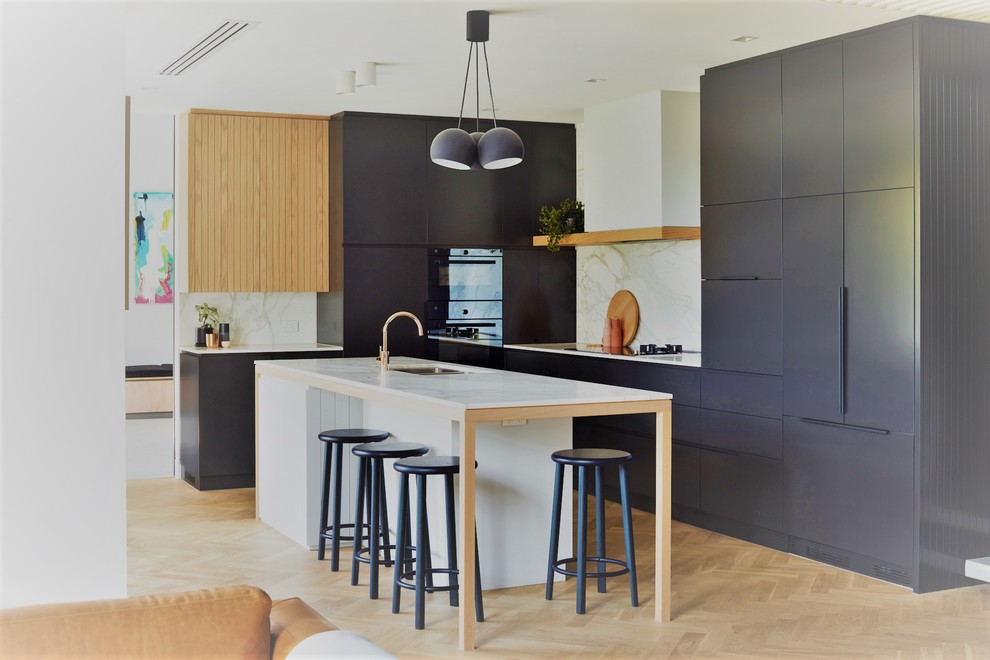 Design ideas for a contemporary l-shaped kitchen in Adelaide with a submerged sink, flat-panel cabinets, grey cabinets, white splashback, integrated appliances, light hardwood flooring, an island, beige floors and white worktops.