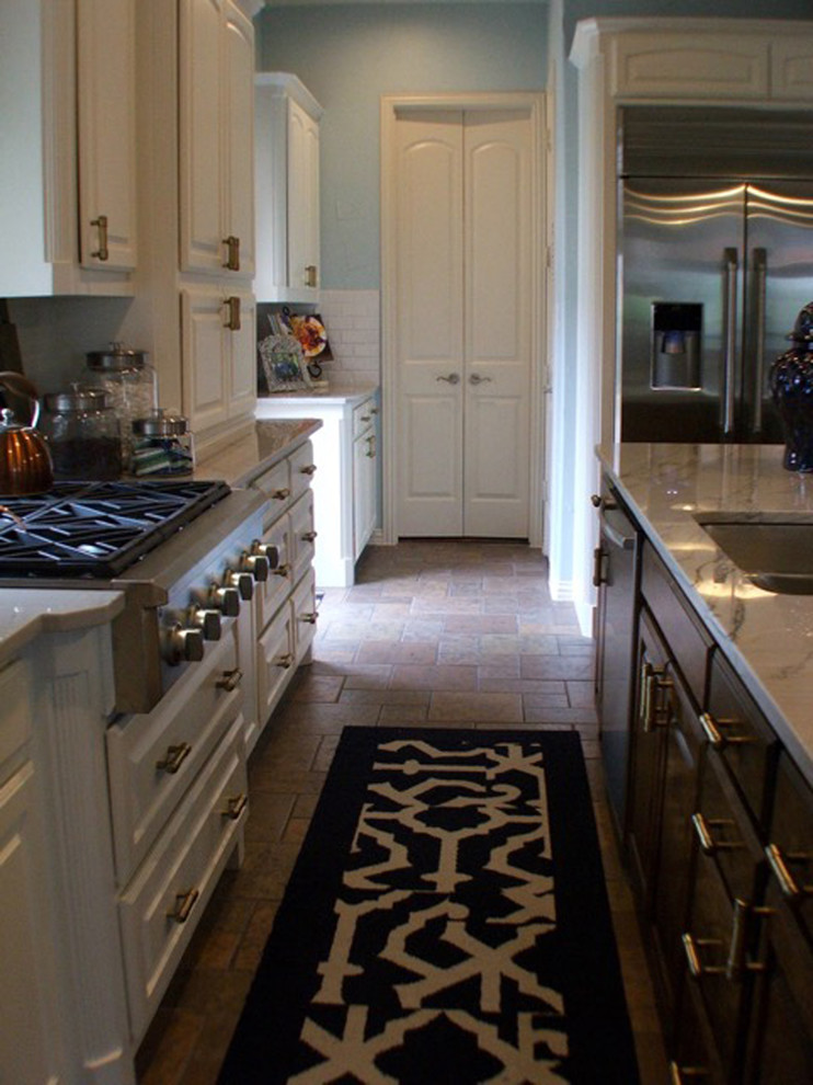 Eat-in kitchen - large transitional l-shaped ceramic tile eat-in kitchen idea in Dallas with an undermount sink, raised-panel cabinets, white cabinets, solid surface countertops, white backsplash, subway tile backsplash, stainless steel appliances and an island