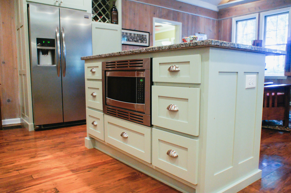 Arts and crafts kitchen photo in Atlanta with shaker cabinets, green cabinets, stainless steel appliances and an island