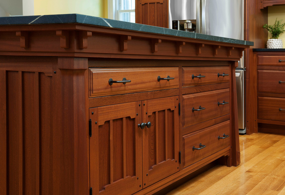 Eat-in kitchen - craftsman u-shaped eat-in kitchen idea in Boston with dark wood cabinets and an island
