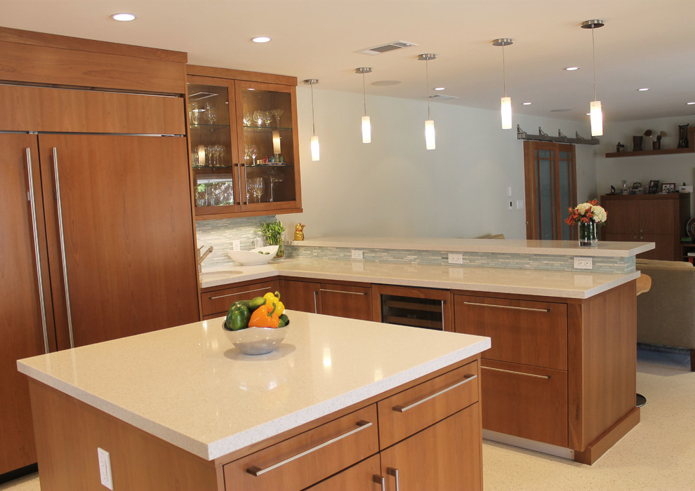 Example of a large 1950s eat-in kitchen design in Los Angeles with an undermount sink, flat-panel cabinets, medium tone wood cabinets, quartz countertops, gray backsplash, matchstick tile backsplash, paneled appliances and two islands