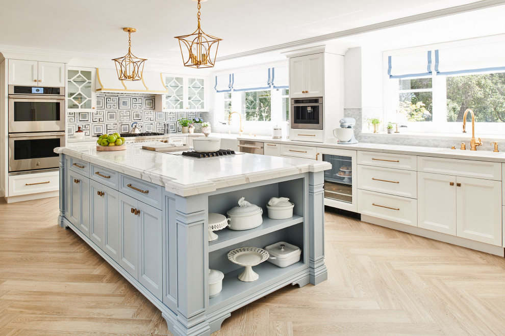 Elegant porcelain tile and beige floor eat-in kitchen photo in Los Angeles with white cabinets, quartz countertops, blue backsplash, stainless steel appliances, white countertops, beaded inset cabinets, marble backsplash and a drop-in sink