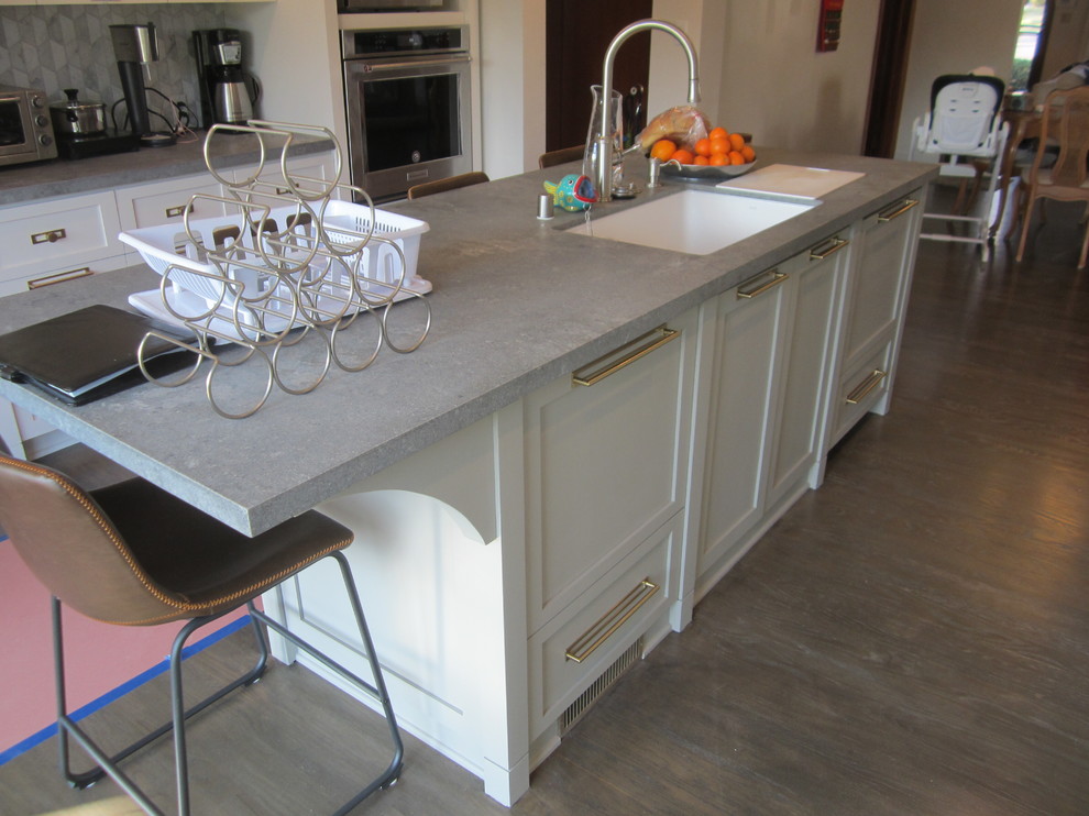Idéer för att renovera ett stort amerikanskt grå grått kök och matrum, med en undermonterad diskho, skåp i shakerstil, vita skåp, bänkskiva i betong, grått stänkskydd, stänkskydd i marmor, rostfria vitvaror, mörkt trägolv, en köksö och flerfärgat golv