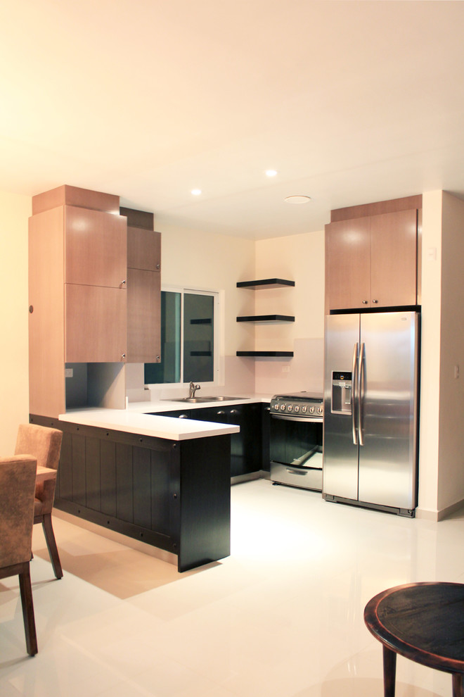 Medium sized urban u-shaped kitchen/diner in Other with a double-bowl sink, flat-panel cabinets, dark wood cabinets, engineered stone countertops, white splashback, stainless steel appliances, porcelain flooring and a breakfast bar.