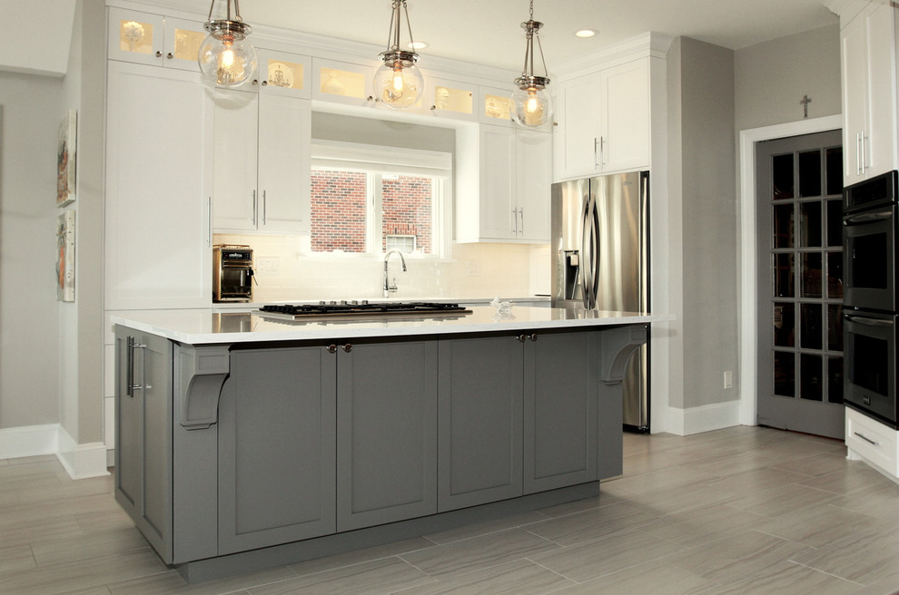 Kitchen - mid-sized modern l-shaped porcelain tile kitchen idea in Charlotte with an undermount sink, shaker cabinets, gray cabinets, glass countertops, white backsplash, porcelain backsplash, stainless steel appliances and an island