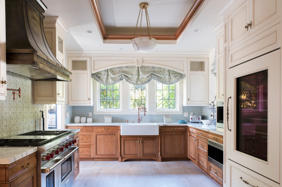 Exempel på ett avskilt klassiskt kök, med en rustik diskho, luckor med profilerade fronter, skåp i mellenmörkt trä, blått stänkskydd, rostfria vitvaror och beiget golv