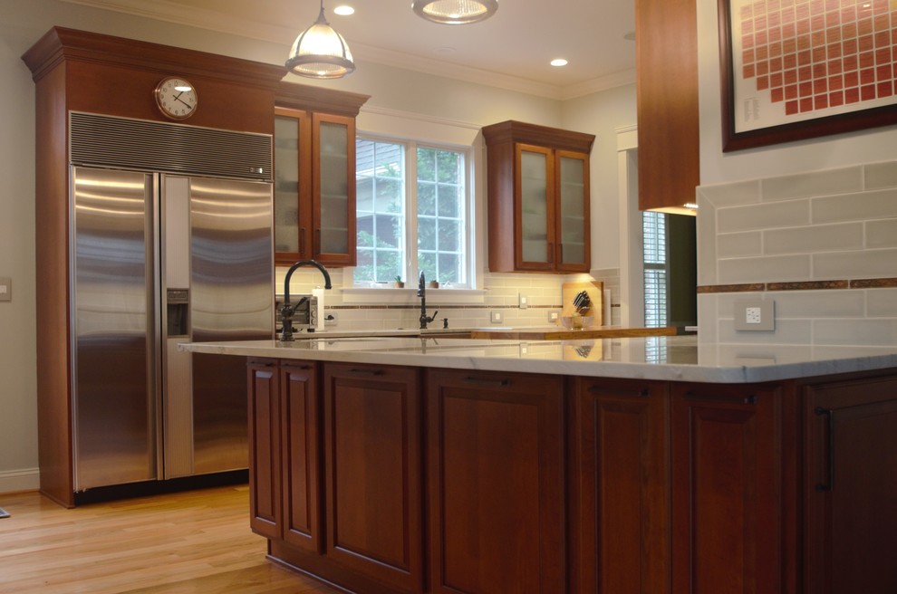 Example of a large classic u-shaped light wood floor and beige floor kitchen pantry design in DC Metro with glass-front cabinets, medium tone wood cabinets, stainless steel appliances, quartzite countertops, green backsplash, porcelain backsplash, a drop-in sink, an island and white countertops