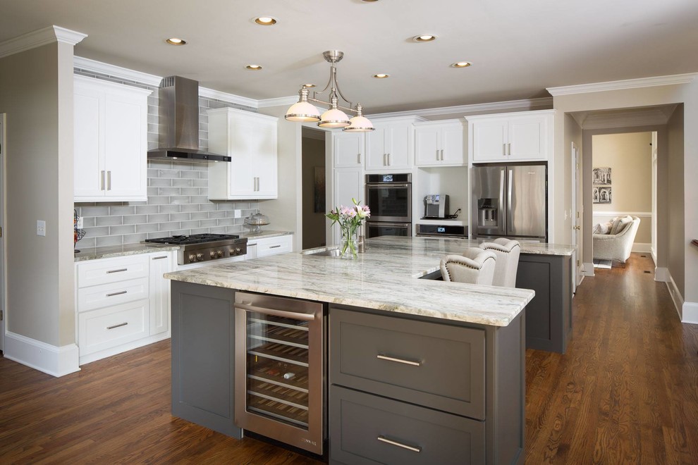 Inspiration for a traditional grey and white kitchen in Other with a submerged sink, shaker cabinets, white cabinets, grey splashback, stainless steel appliances, medium hardwood flooring and an island.
