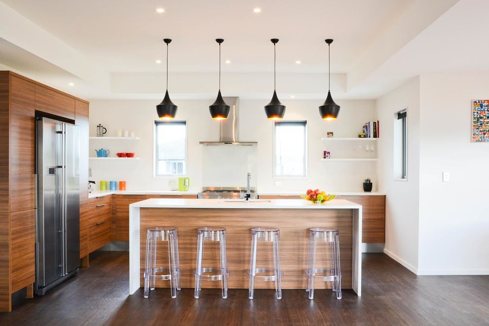 Photo of a contemporary l-shaped kitchen in Auckland with flat-panel cabinets, medium wood cabinets and stainless steel appliances.