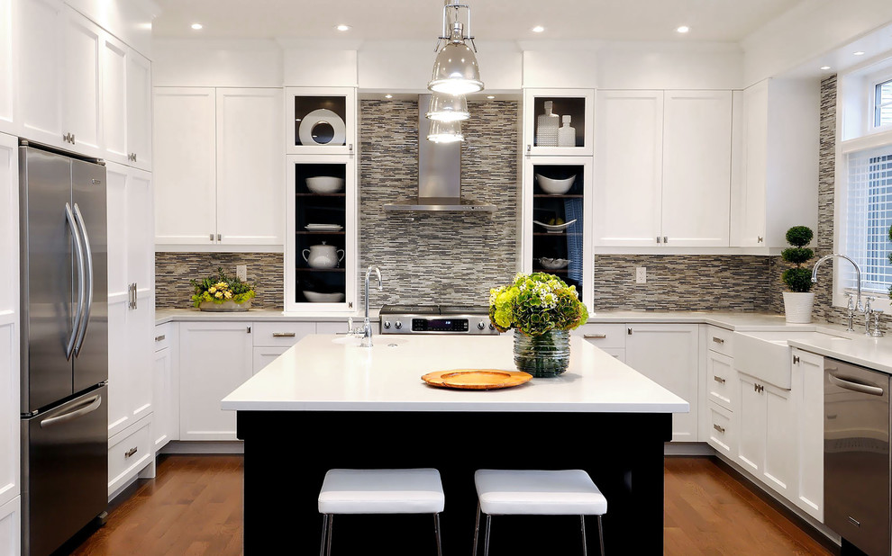 Inspiration for a transitional u-shaped kitchen remodel in Other with glass-front cabinets, stainless steel appliances, a farmhouse sink, white cabinets, multicolored backsplash and matchstick tile backsplash