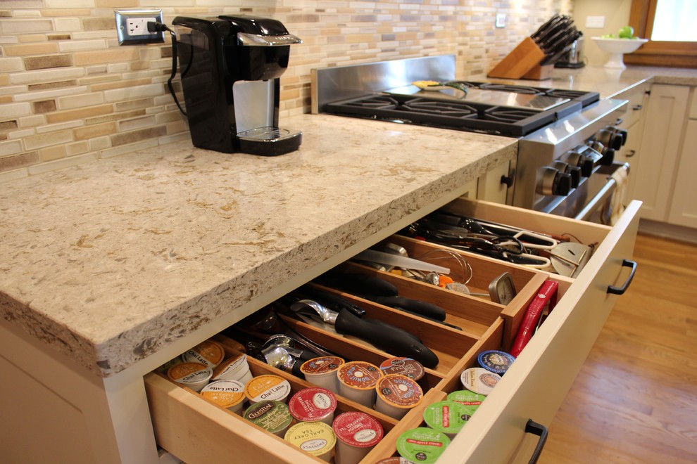 Cette image montre une cuisine encastrable craftsman en U avec un évier 1 bac, un placard à porte shaker, un plan de travail en quartz modifié et un sol en bois brun.