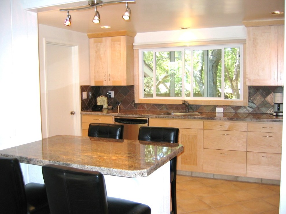 Eat-in kitchen - small modern l-shaped porcelain tile eat-in kitchen idea in Sacramento with an undermount sink, shaker cabinets, medium tone wood cabinets, granite countertops, multicolored backsplash, stone tile backsplash and stainless steel appliances