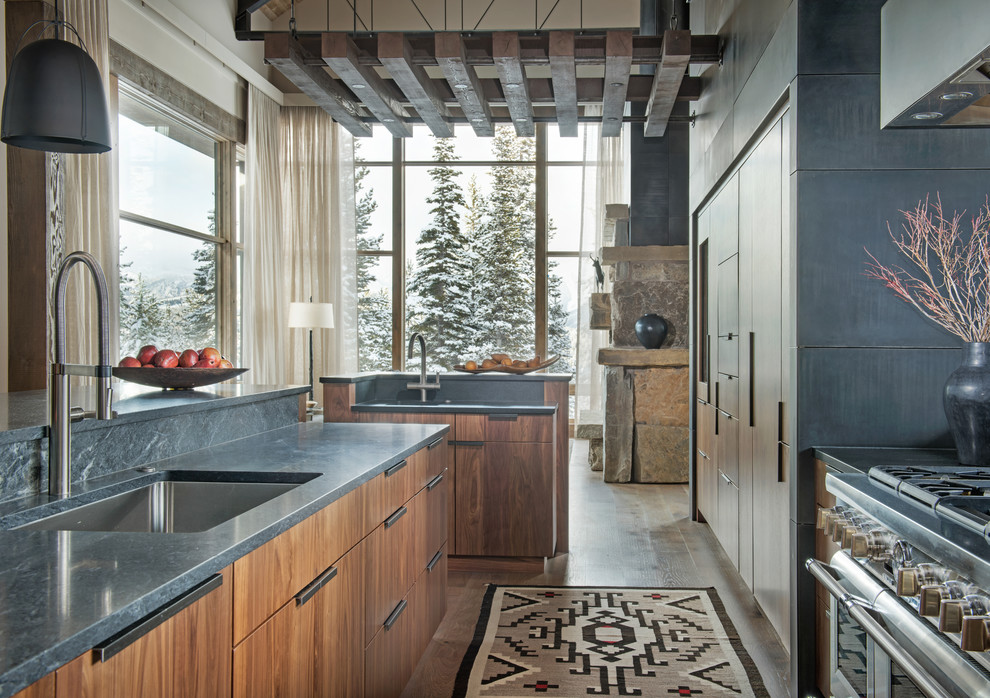 Immagine di una cucina rustica con lavello sottopiano, ante lisce, ante in legno scuro, parquet scuro e pavimento marrone