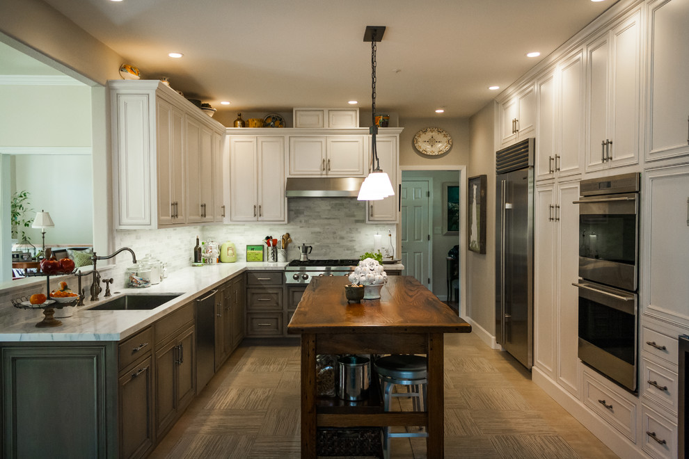 This is an example of a medium sized farmhouse galley kitchen/diner in San Francisco with a submerged sink, beaded cabinets, grey cabinets, marble worktops, grey splashback, stone tiled splashback, stainless steel appliances, medium hardwood flooring and an island.