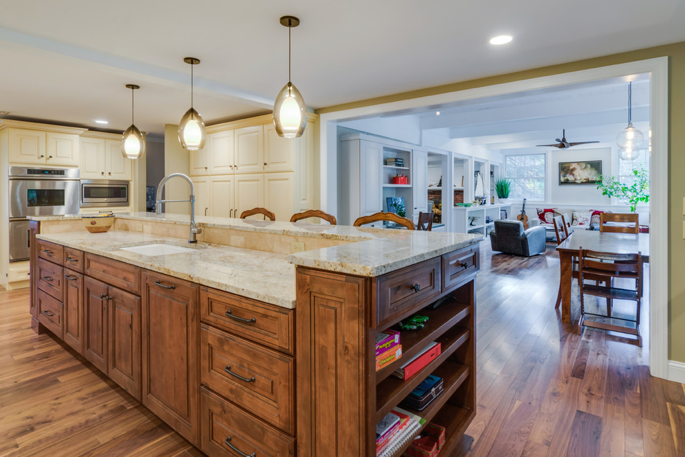 Photo of a traditional u-shaped kitchen pantry in Philadelphia with raised-panel cabinets, white cabinets, granite worktops, beige splashback, medium hardwood flooring and an island.