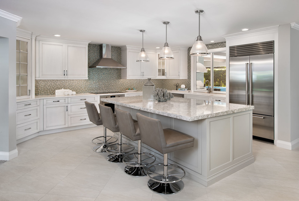Photo of a large contemporary u-shaped enclosed kitchen in Miami with a double-bowl sink, granite worktops, multi-coloured splashback, stainless steel appliances, travertine flooring, an island, shaker cabinets, white cabinets and mosaic tiled splashback.