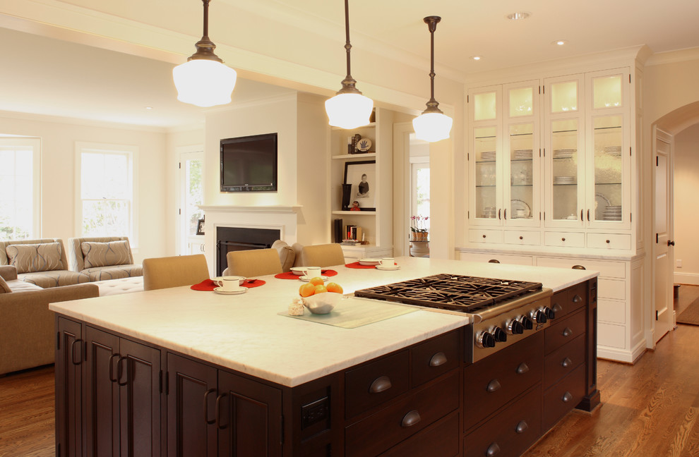 Example of a large transitional single-wall dark wood floor eat-in kitchen design in Portland with recessed-panel cabinets, white cabinets, marble countertops, white backsplash, stone slab backsplash, paneled appliances and an island