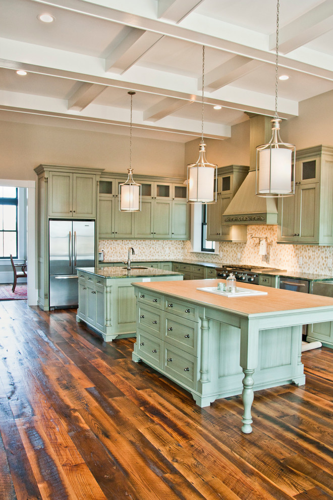 Example of a large transitional l-shaped dark wood floor open concept kitchen design in Other with a single-bowl sink, shaker cabinets, green cabinets, multicolored backsplash, mosaic tile backsplash, stainless steel appliances and two islands