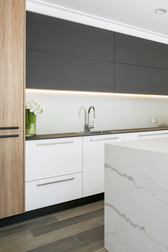 Inspiration for a large contemporary single-wall porcelain tile and brown floor open concept kitchen remodel in Sydney with a drop-in sink, flat-panel cabinets, brown cabinets, quartz countertops, metallic backsplash, porcelain backsplash, stainless steel appliances, an island and white countertops
