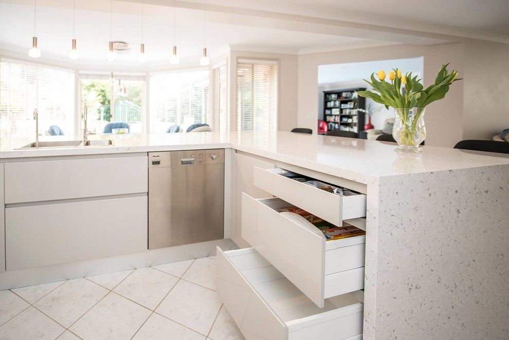 Design ideas for a large contemporary u-shaped open plan kitchen in Sydney with a built-in sink, flat-panel cabinets, white cabinets, engineered stone countertops, marble splashback, stainless steel appliances, ceramic flooring, an island, grey splashback and grey worktops.