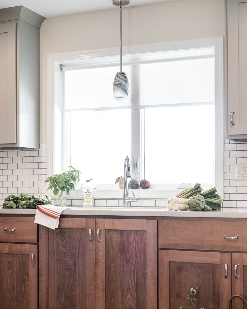 Inspiration for a mid-sized mediterranean u-shaped linoleum floor and brown floor eat-in kitchen remodel in Columbus with recessed-panel cabinets, gray cabinets, solid surface countertops, white backsplash, subway tile backsplash, a peninsula, gray countertops, an undermount sink and white appliances