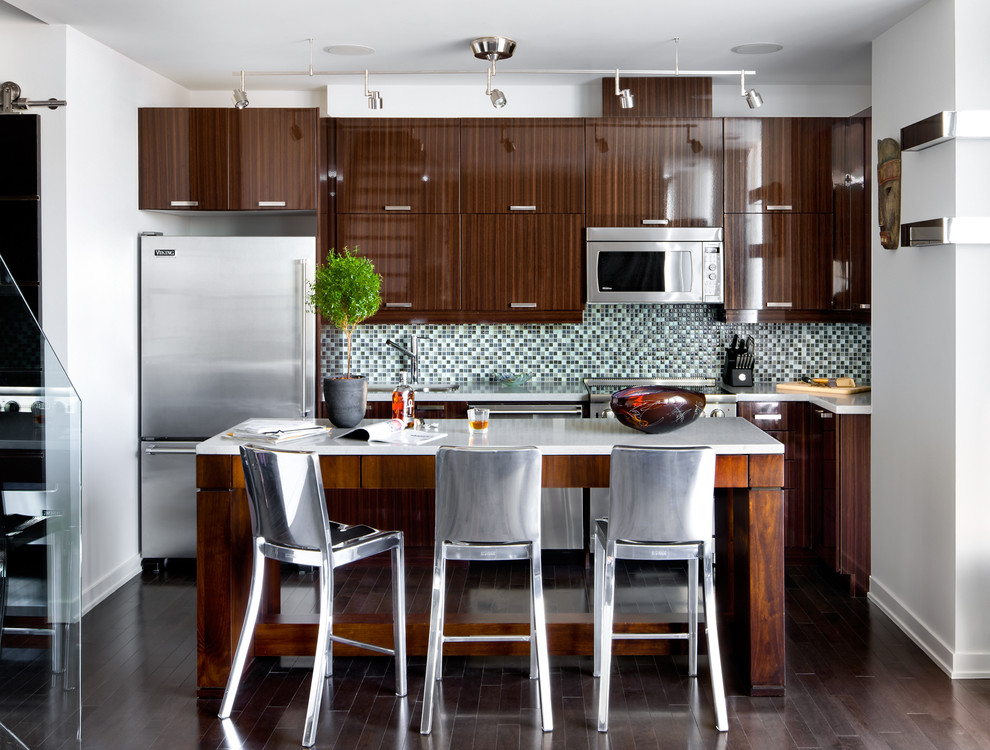 Trendy l-shaped kitchen photo in Toronto with flat-panel cabinets, dark wood cabinets, multicolored backsplash and stainless steel appliances