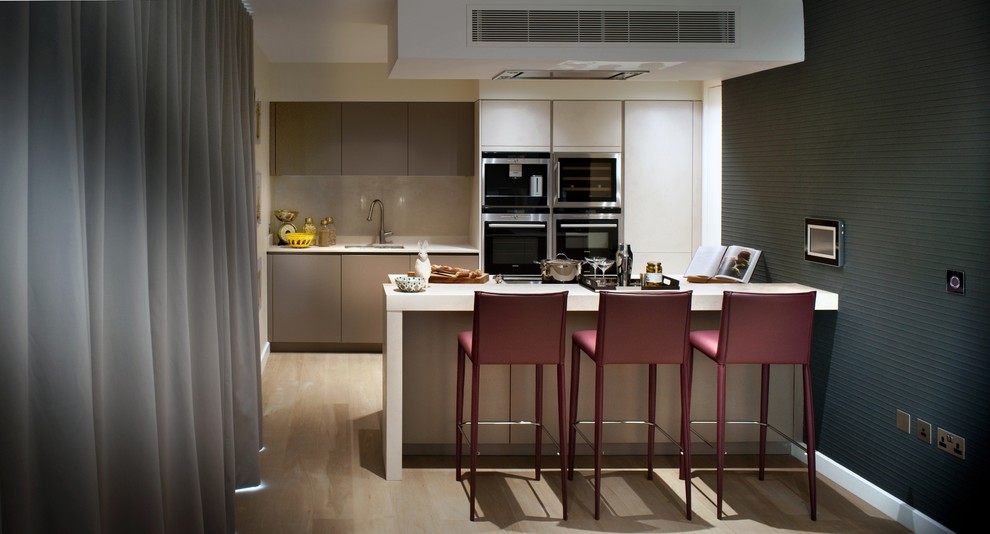 Mid-sized trendy single-wall medium tone wood floor eat-in kitchen photo in London with an island