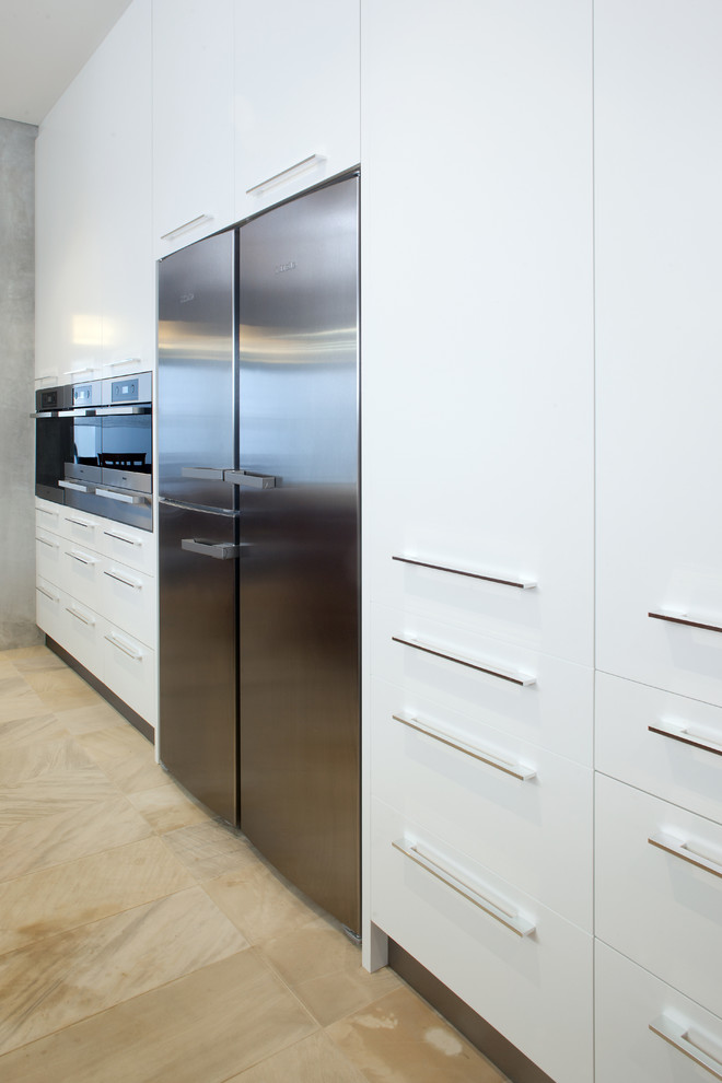 Photo of a large modern kitchen in Perth with flat-panel cabinets, white cabinets and stainless steel appliances.