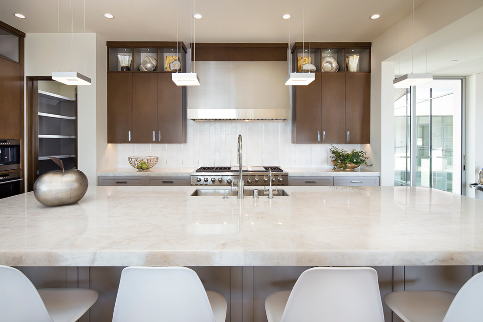 Contemporary kitchen in Orange County with a submerged sink, flat-panel cabinets, dark wood cabinets, metallic splashback, stainless steel appliances, an island and quartz worktops.
