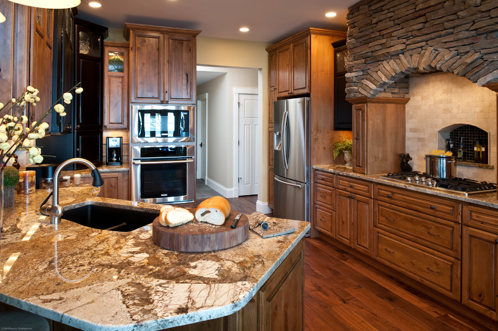 Example of a mountain style medium tone wood floor kitchen design in Other