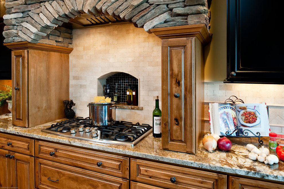 Kitchen - rustic kitchen idea in Other with recessed-panel cabinets, granite countertops and stainless steel appliances