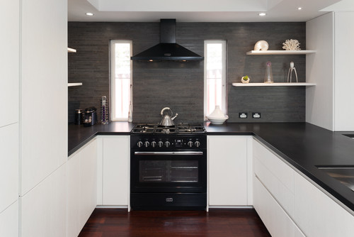 modern white kitchen cabinets with black countertops