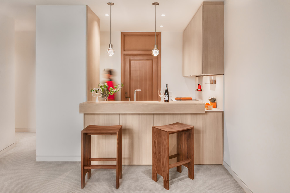 Design ideas for a small contemporary l-shaped open plan kitchen in Seattle with a submerged sink, flat-panel cabinets, light wood cabinets, engineered stone countertops, white splashback, stainless steel appliances, no island and white worktops.