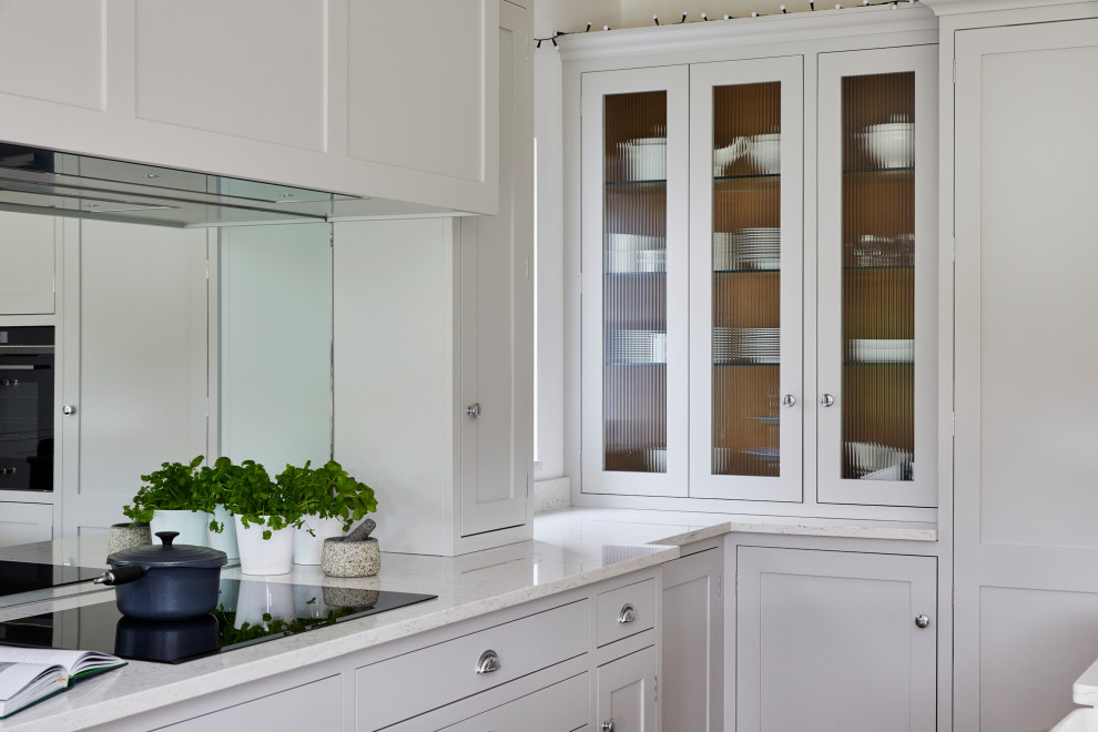 Foto di una grande cucina design con lavello a doppia vasca e top bianco