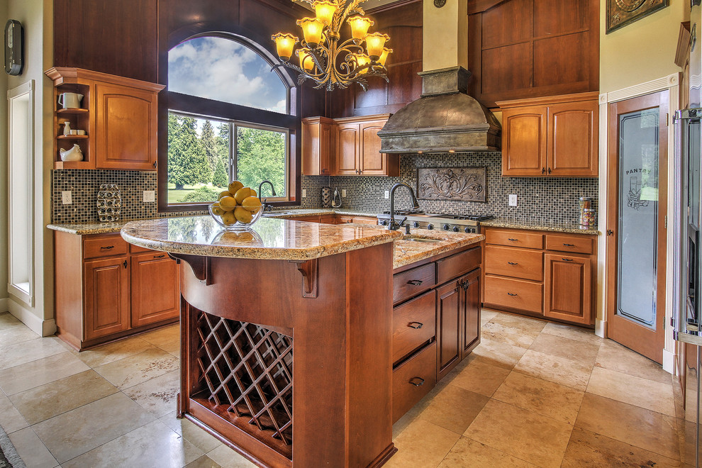 Example of a tuscan l-shaped kitchen design in Seattle with an undermount sink, raised-panel cabinets, medium tone wood cabinets, granite countertops, multicolored backsplash, mosaic tile backsplash and an island
