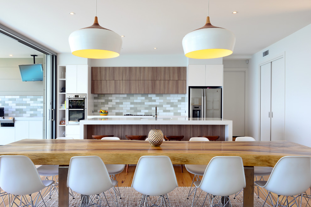 Medium sized contemporary galley kitchen/diner in Wollongong with a double-bowl sink, flat-panel cabinets, medium wood cabinets, engineered stone countertops, grey splashback, terracotta splashback, stainless steel appliances, medium hardwood flooring and an island.