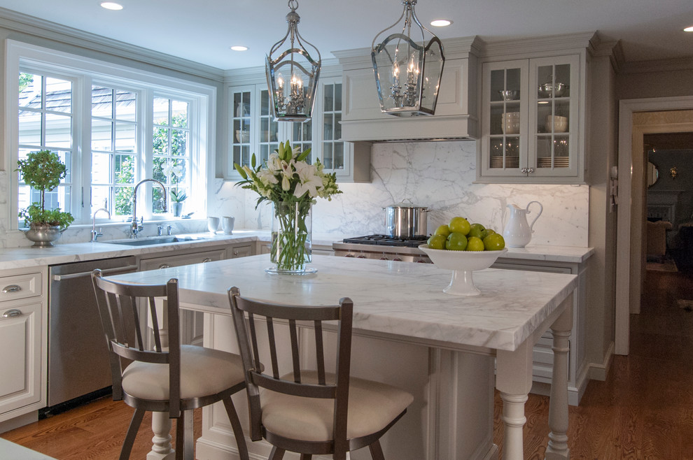 Elegant l-shaped medium tone wood floor eat-in kitchen photo in Philadelphia with beaded inset cabinets, gray cabinets, marble countertops, white backsplash, stone slab backsplash, stainless steel appliances, an island and an undermount sink