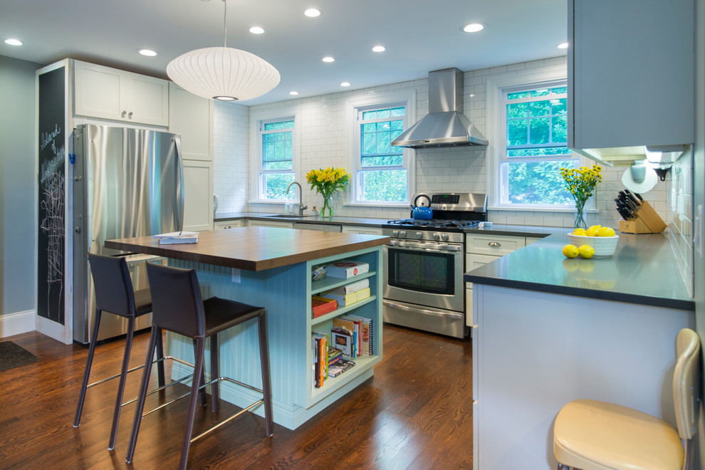 Eat-in kitchen - large transitional u-shaped dark wood floor and brown floor eat-in kitchen idea in Philadelphia with an undermount sink, shaker cabinets, white cabinets, white backsplash, stainless steel appliances and an island