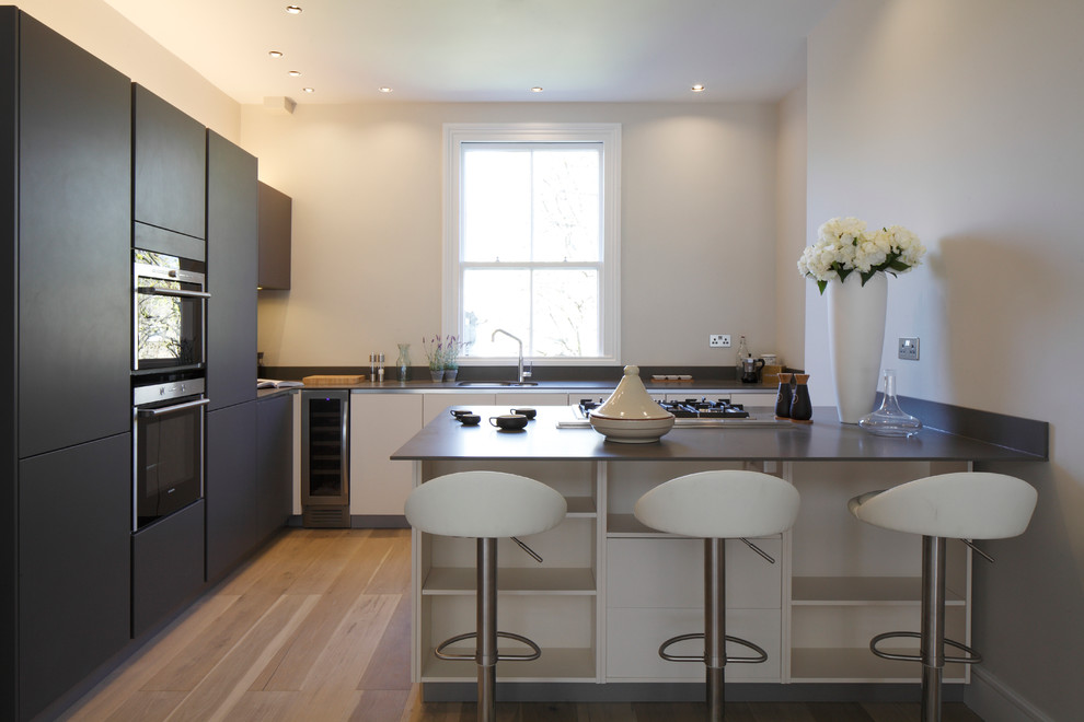 This is an example of a contemporary kitchen in Hampshire.